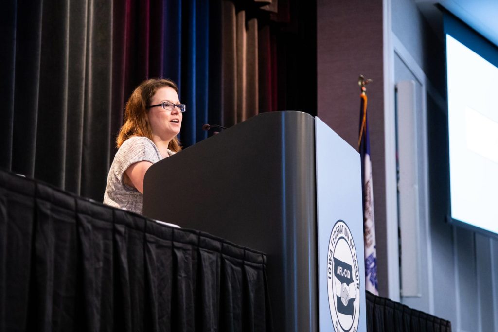 Photo of Emily Holley speaking at a podium