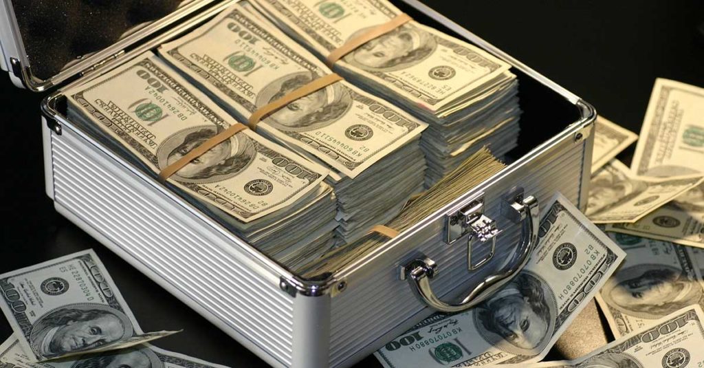 A suitcase overflowing with money